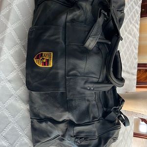 New black leather duffle by Porsche.